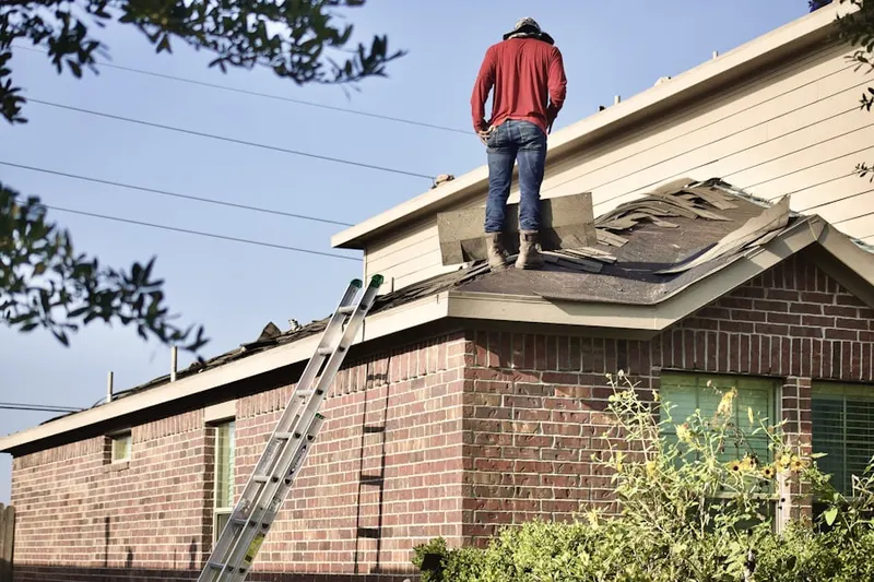 Professional roofer working on a residential roof in Fox River Estates